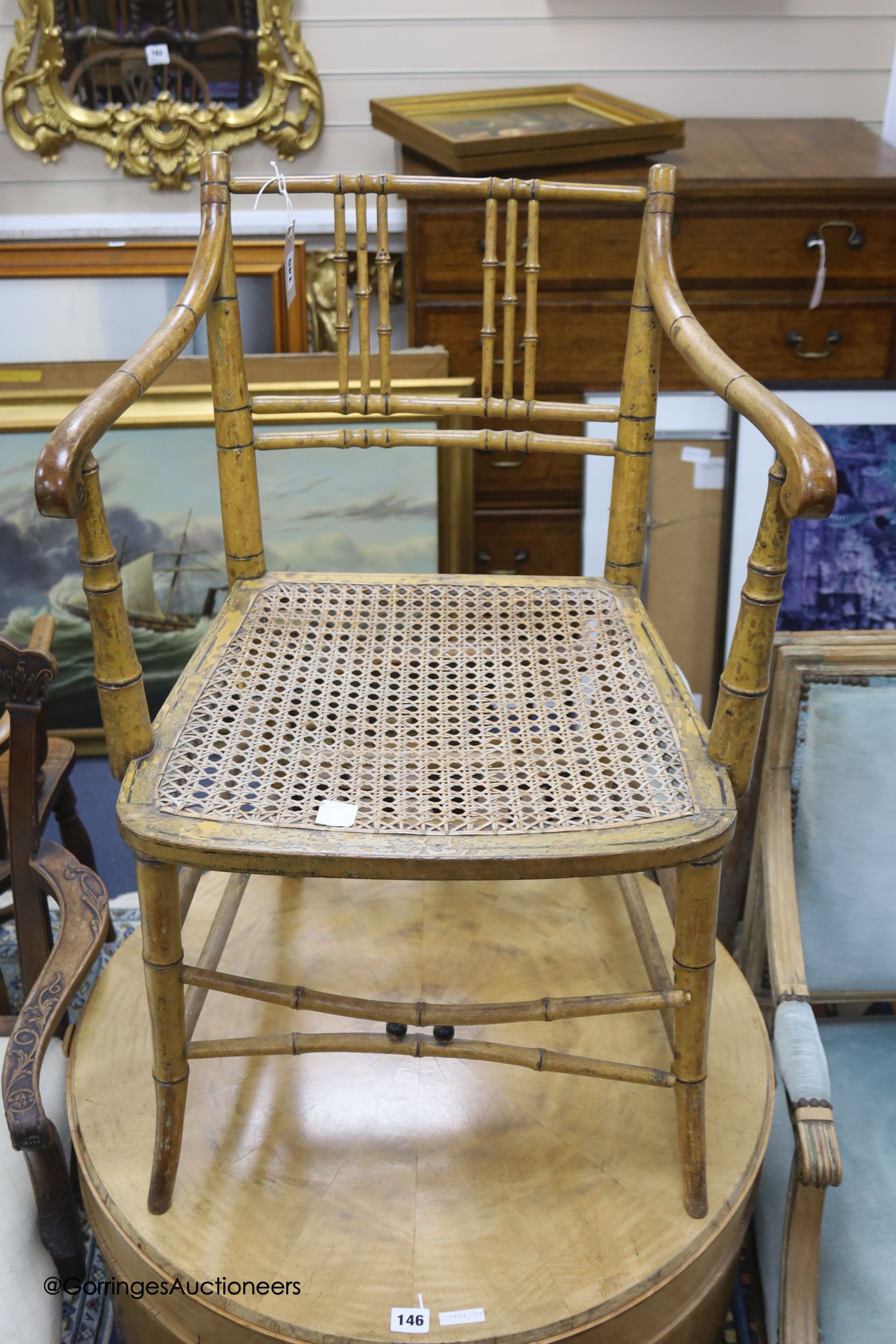 An early 19th century simulated bamboo elbow chair, cane seat